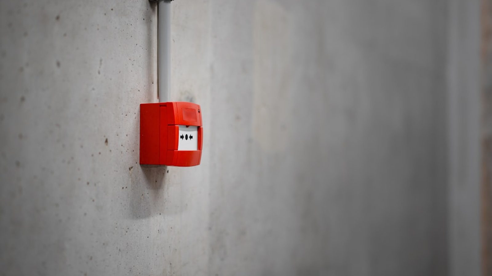 Security alarm control keypad mounted on an interior wall